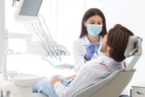 A Dentist Working on a Patient
